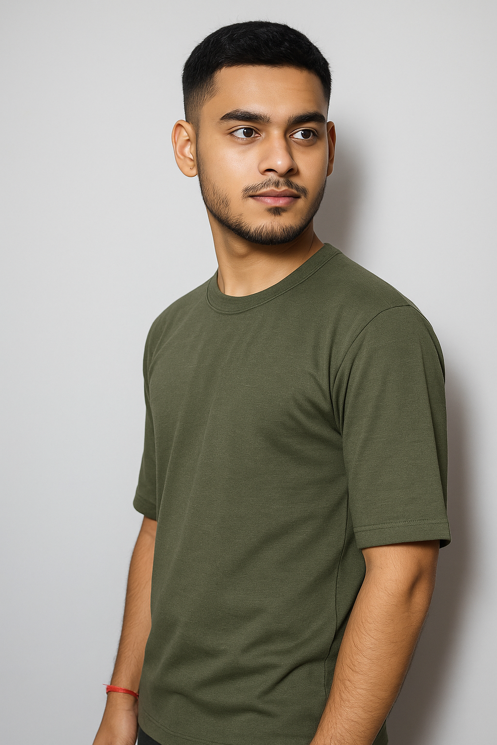 Man wearing an olive green t-shirt against a plain background