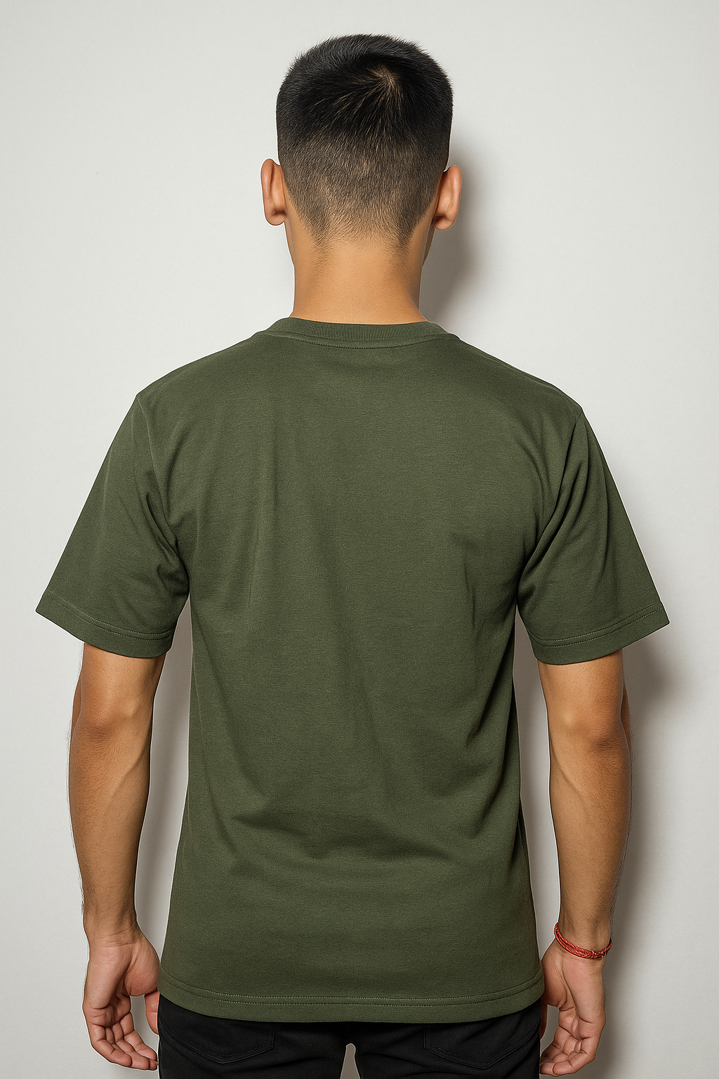 Person wearing a green t-shirt against a plain background