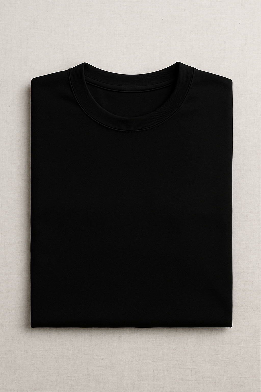 Folded black t-shirt on a light gray background