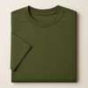 Folded green t-shirt on a beige background