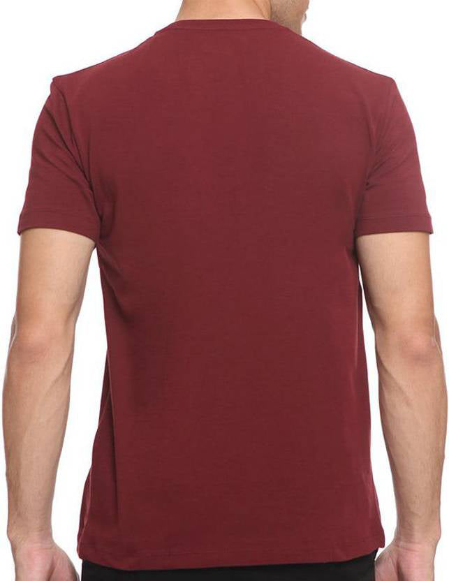 Maroon t-shirt worn by a person on a white background